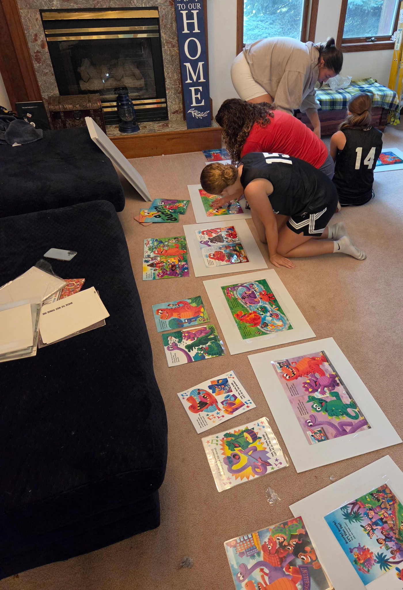 Ellie Mister, Aubrey Stewart, and helper working on book walk signs